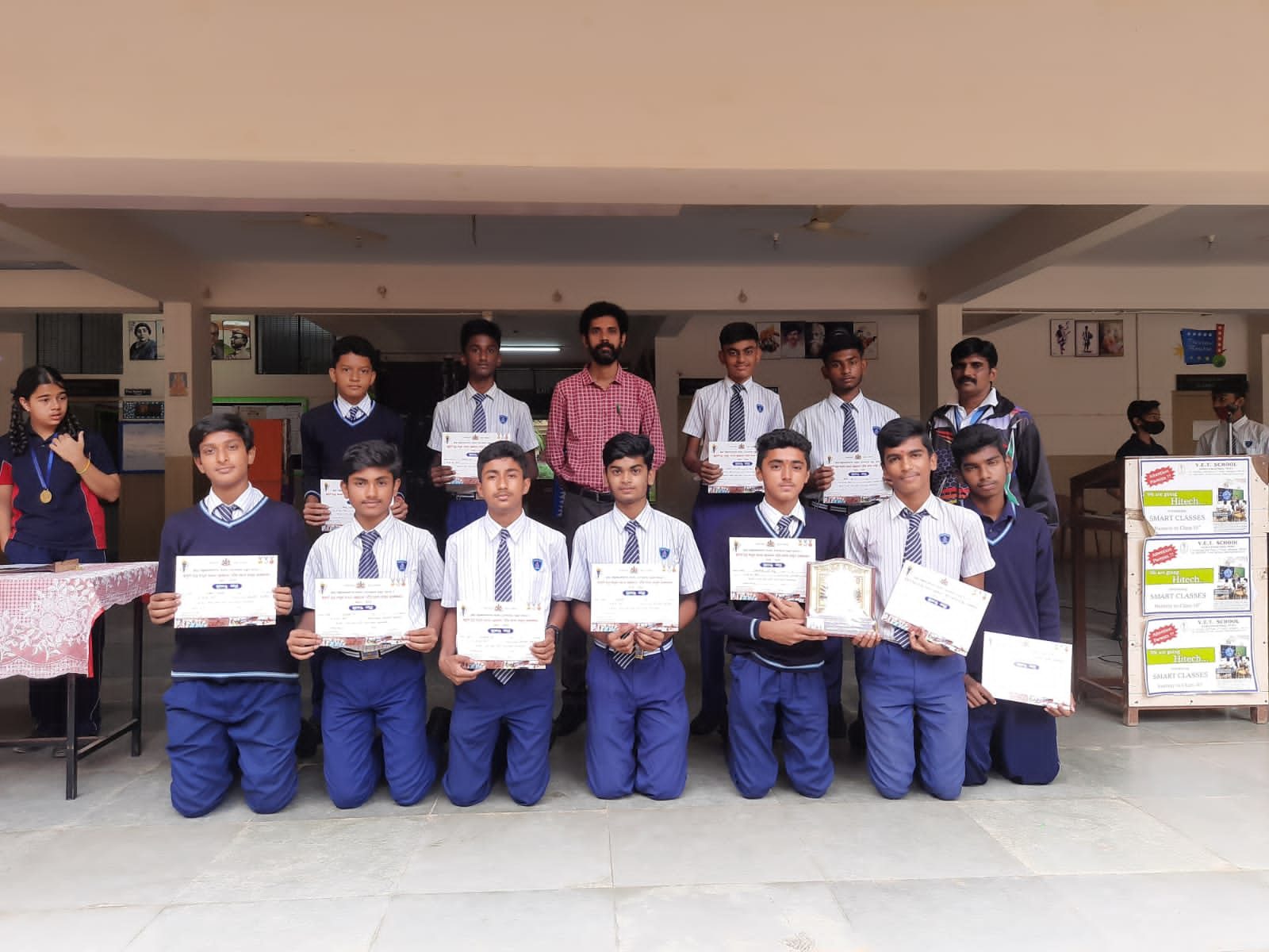 Boys’ volleyball team with certificates and a trophy after the taluk-level competition