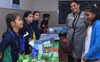 Students presenting a project at a school exhibition