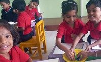 Kindergarten children working together on a classroom activity